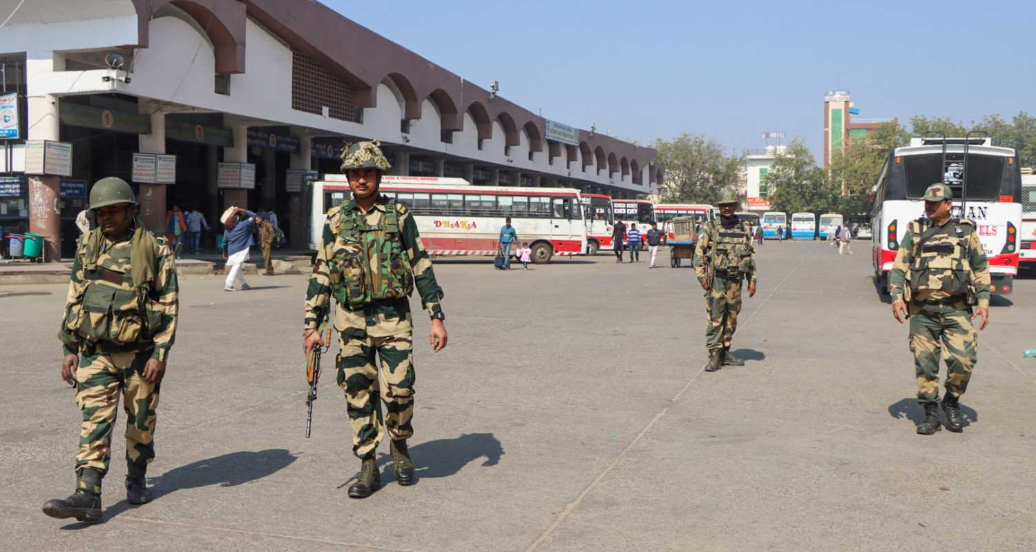 Security personnel keep a vigil at the Rohtak Bus Depot during 'Bharat Bandh', in Rohtak, Friday, Feb. 16, 2024. The Samyukta Kisan Morcha (SKM) has called for the 'Bharat Bandh' to press the BJP-led central government to accept farmers' demands, including a legal guarantee of minimum support price (MSP) for crops.