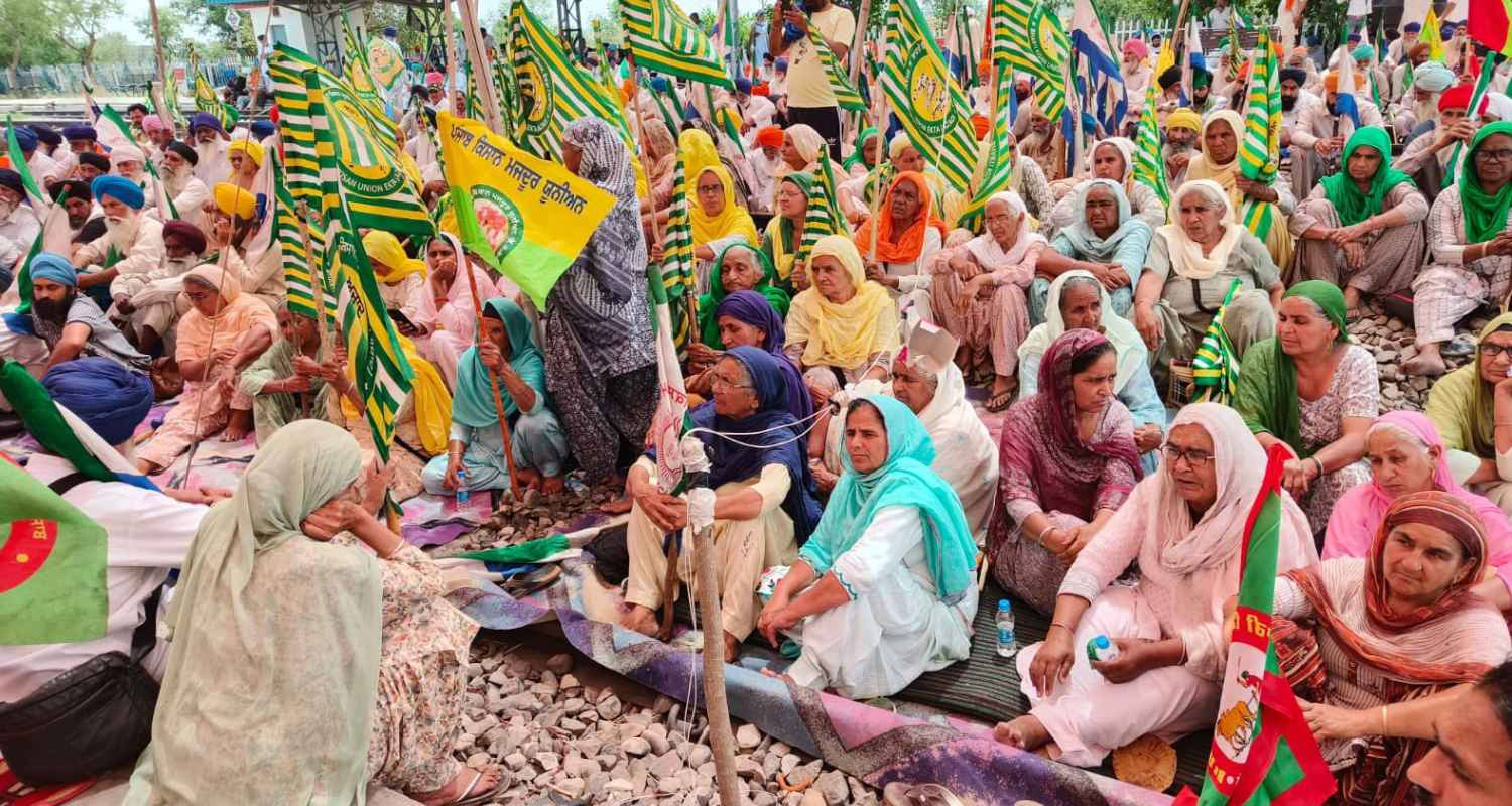 Farmers sitting on rails. 