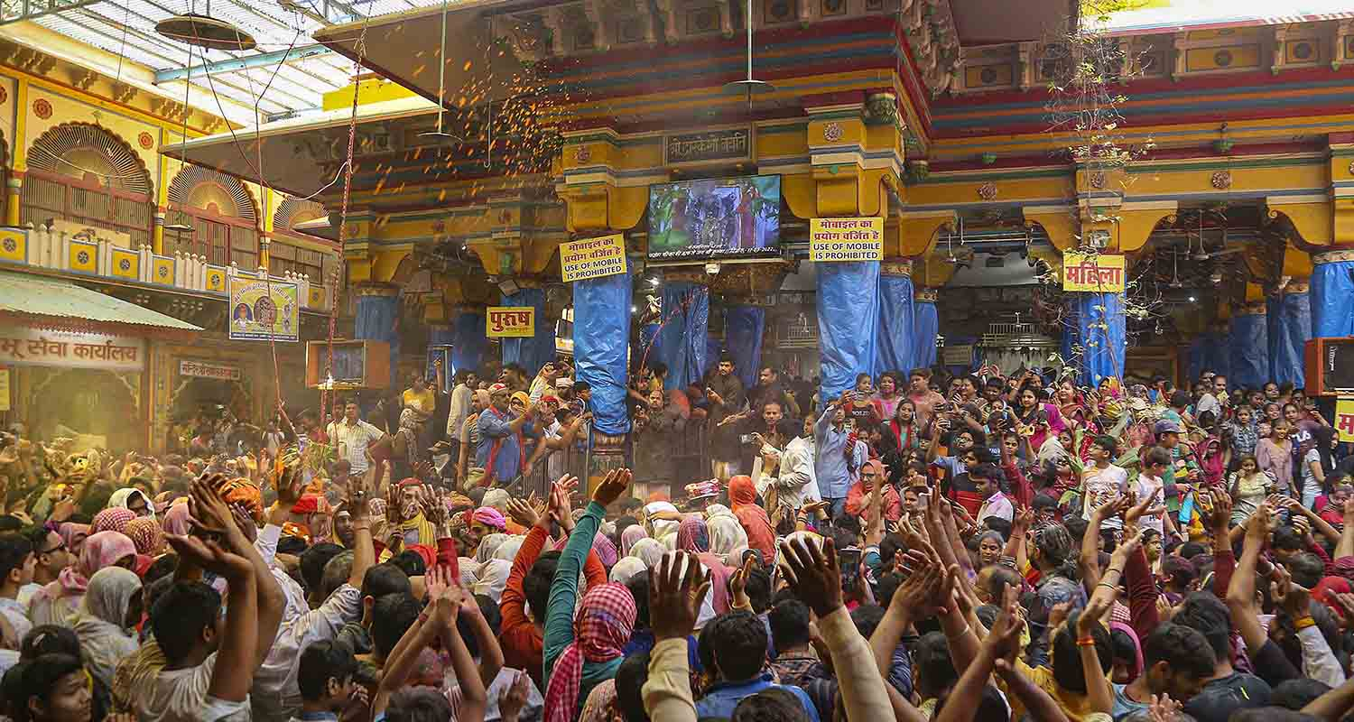Devotees celebrate with colours during Holi celebration at the Dwarkadhish Temple, in Mathura, Wednesday
