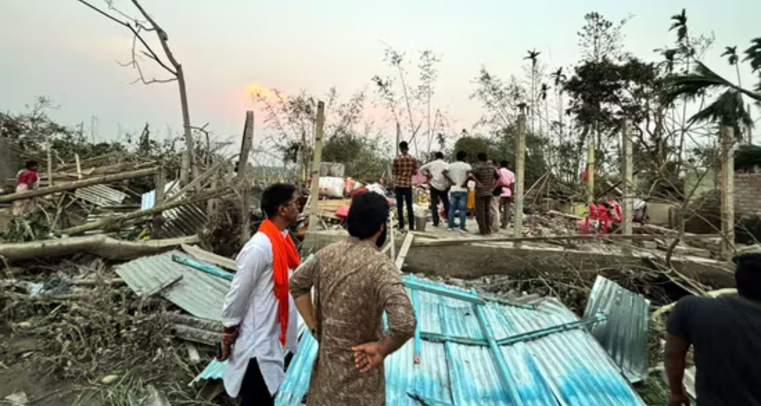 Houses are damaged and electric poles fell after a heavy storm that left at least five people dead, in Jalpaiguri, West Bengal, on March 31. 