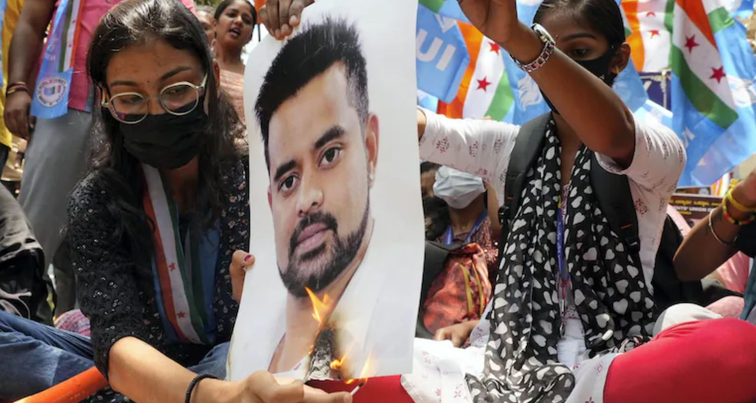People burning Prajwal's poster. 