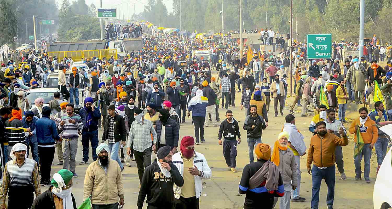 Farmers move away after police fired teargas shell to disperse them during their 'Delhi Chalo' march at Punjab-Haryana Shambhu border, near Patiala, Tuesday. 