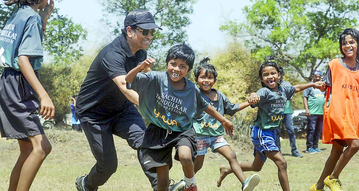 Former cricketer Sachin Tendulkar with wife Anjali Tendulkar pose for group photos with budding football players of Yuwa Foundation, in Ranchi
