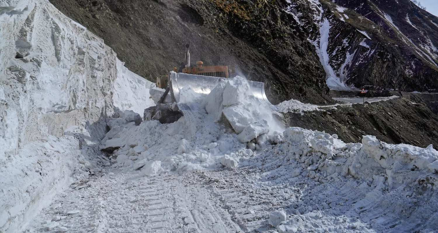 Heavy Snowfall on the road, an excavator attempts to clear out the snow