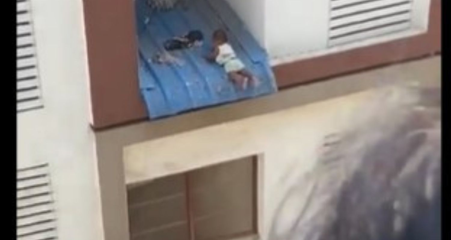 Toddler hanging from window.