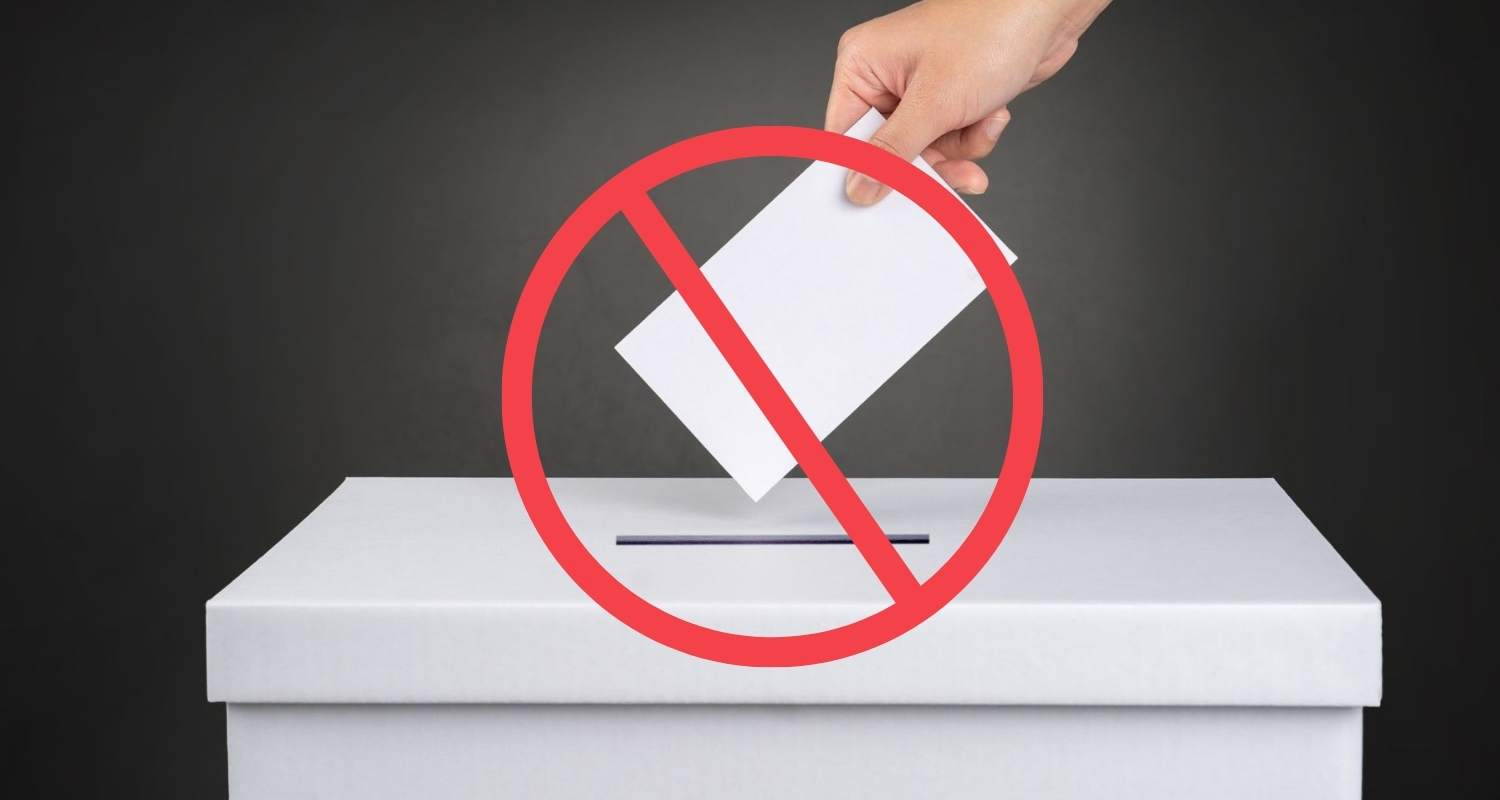 Image of person voting with abstain sign. 