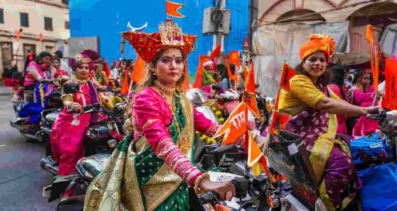 Women dressed in traditional attire participate in a rally on the occasion of ‘Gudi Padwa’