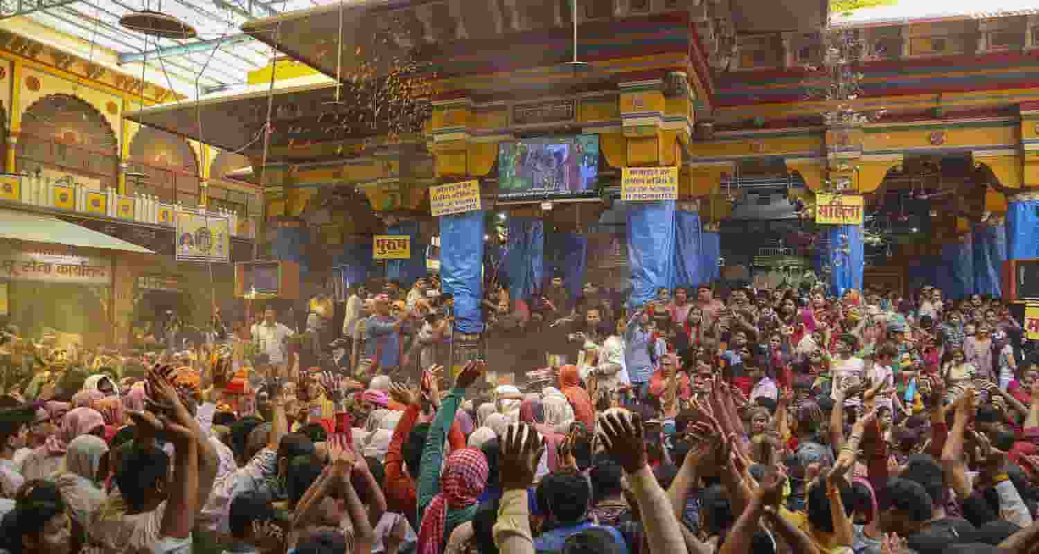 Devotees celebrate with colours during Holi celebration at the Dwarkadhish Temple, in Mathura, Wednesday