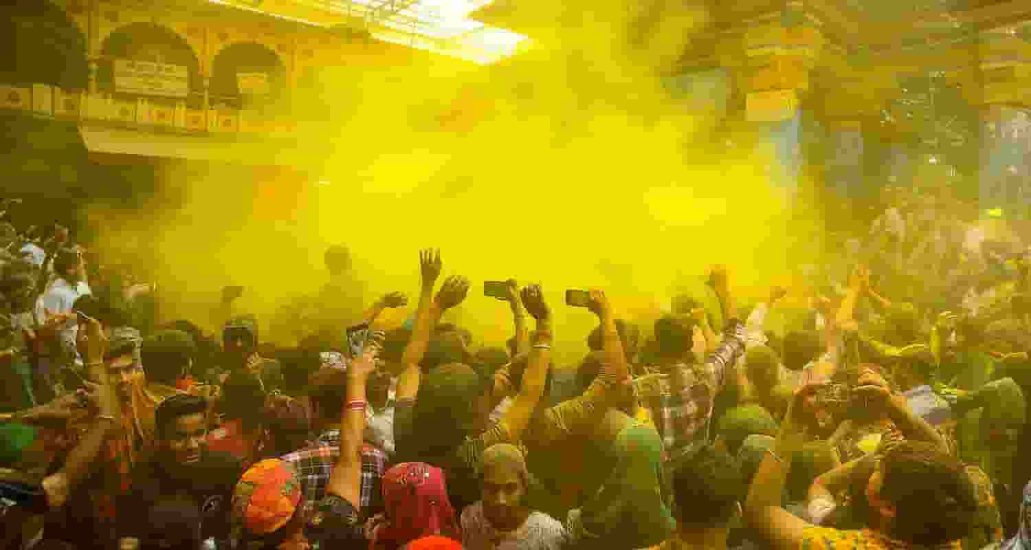 Devotees celebrate with colours during Holi celebration at the Dwarkadhish Temple, in Mathura