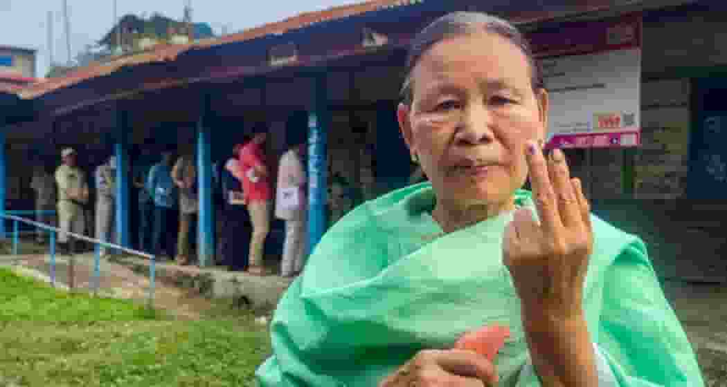 A voter shows her finger marked with indelible ink after casting her vote for Lok Sabha elections, during repolling at 11 polling stations in the Inner Manipur Lok Sabha constituency, Monday.
