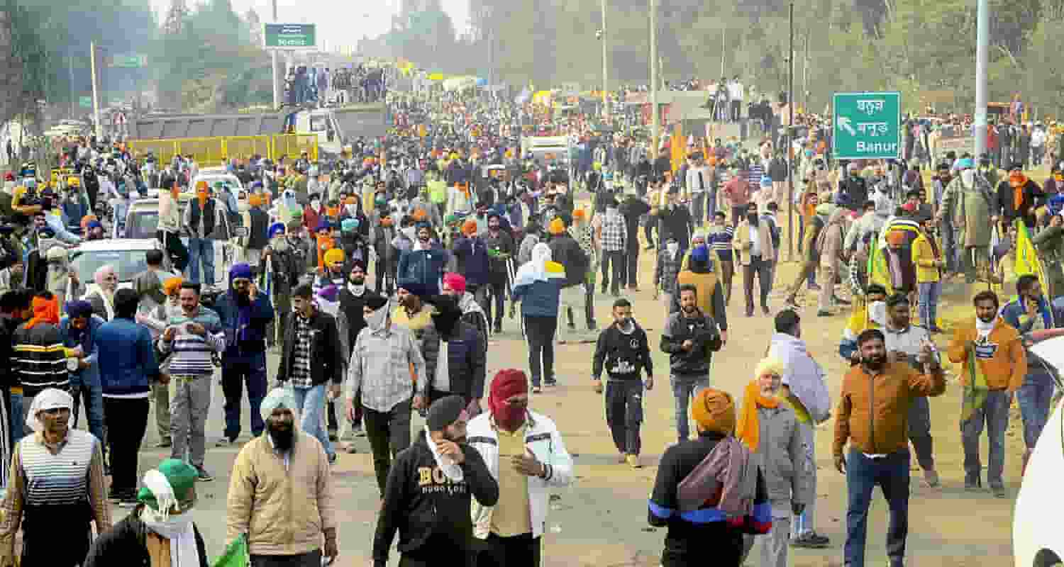 Farmers move away after police fired teargas shell to disperse them during their 'Delhi Chalo' march at Punjab-Haryana Shambhu border, near Patiala, Tuesday. 