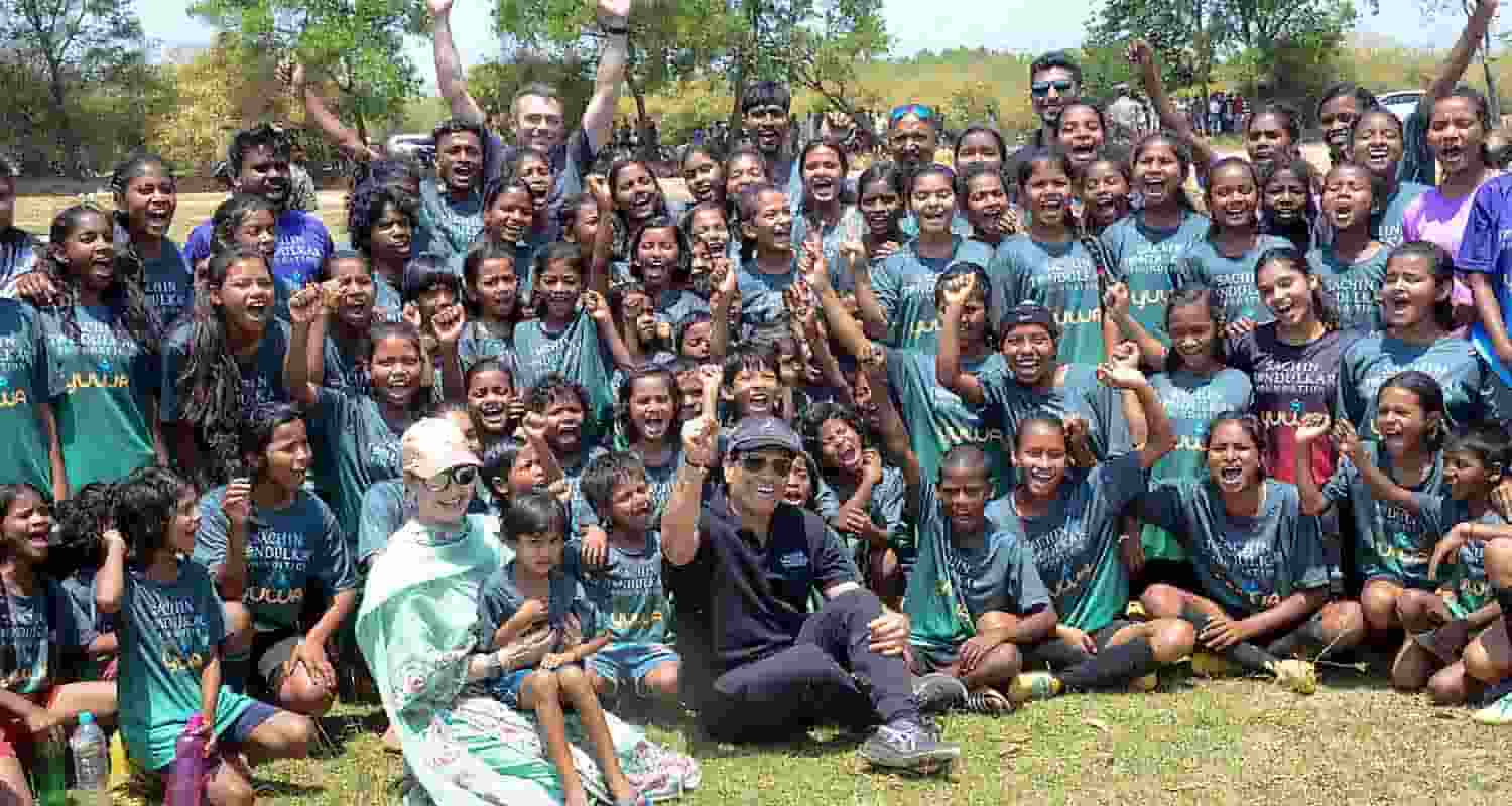 Former cricketer Sachin Tendulkar with wife Anjali Tendulkar pose for group photos with budding football players of Yuwa Foundation, in Ranchi