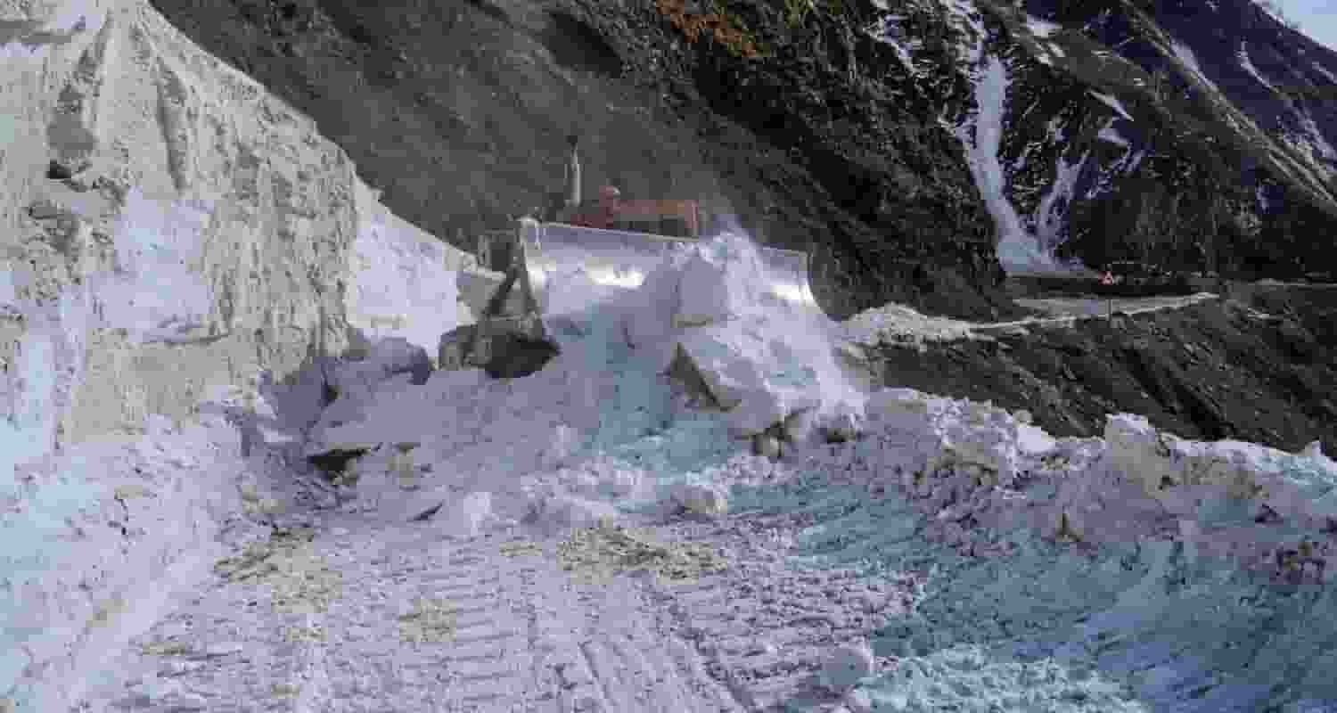 Heavy Snowfall on the road, an excavator attempts to clear out the snow