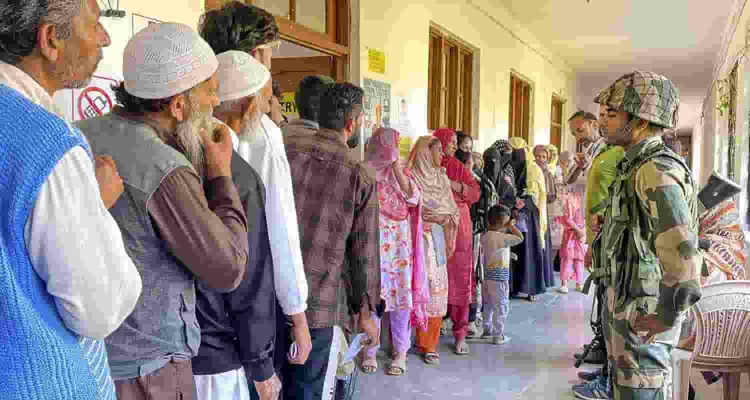 Voters line up outside a polling station in Baramulla, Jammu and Kashmir.
