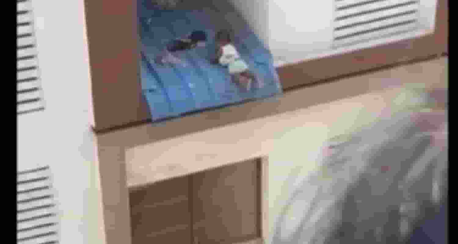 Toddler hanging from window.