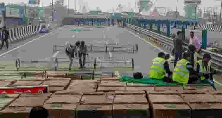 Iron barricades being installed in view of the farmers' march at the Kundli-Singhu border, in Sonipat