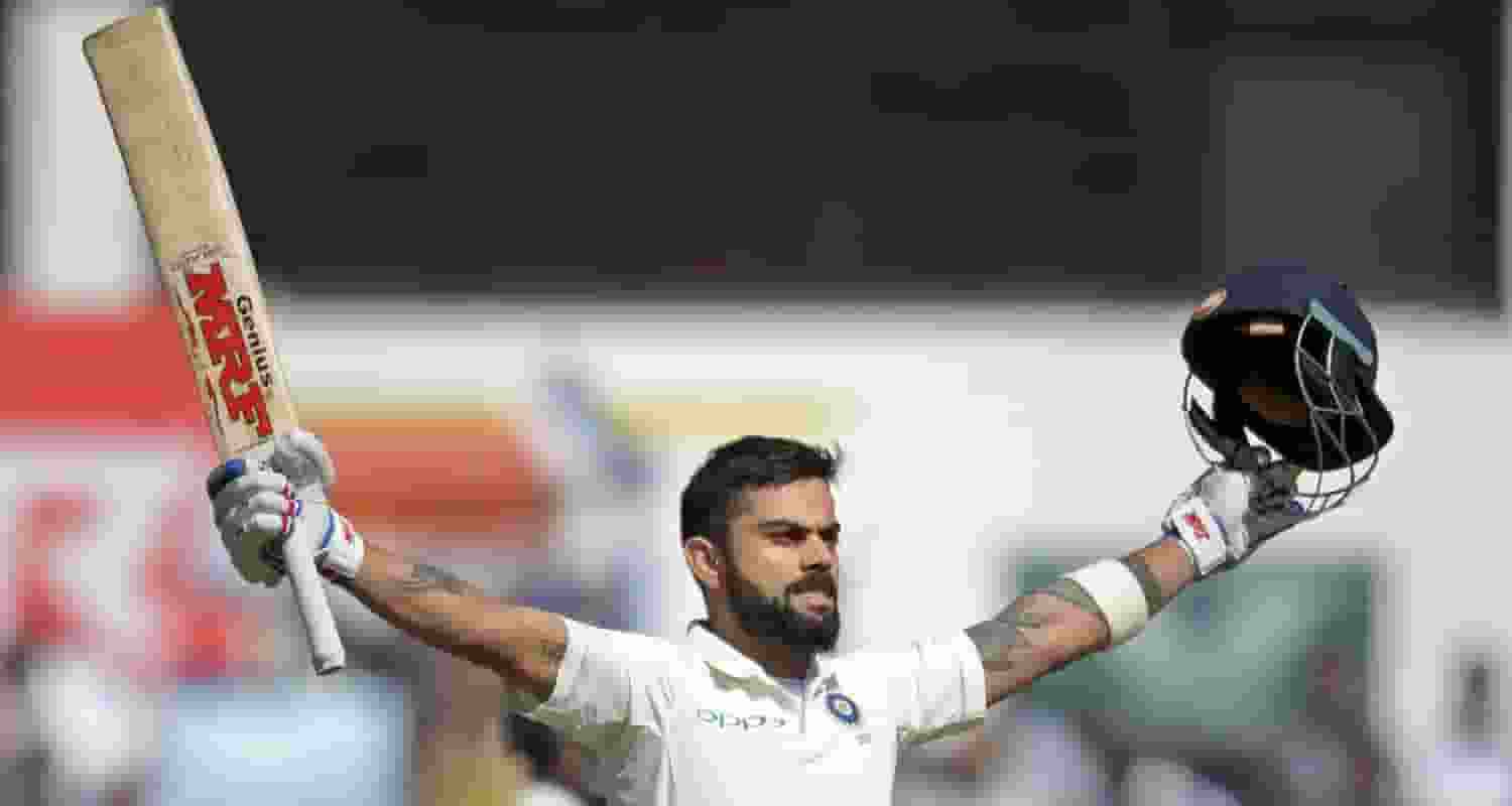 Virat Kohli celebrates a century 