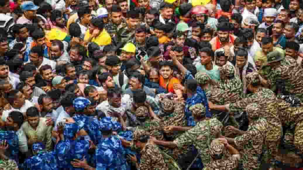 Security personnel controlling mob। Photo Credit: PTI